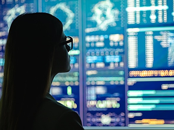 Female looking at data on screens